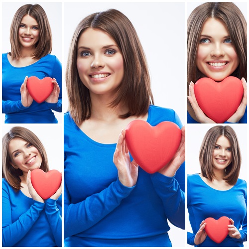 Beautiful brunette woman with decorative red heart - stock photo